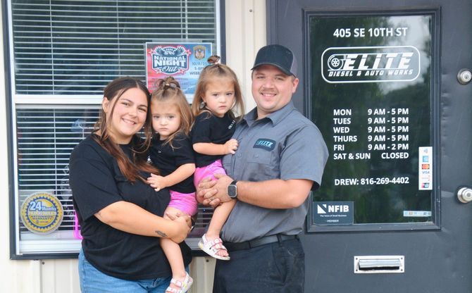 The family behind Elite Diesel & Auto Works standing in front of the shop's front counter