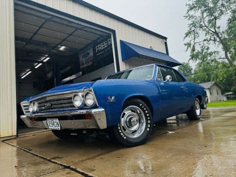 Blue classic Chevrolet Chevelle outside the shop