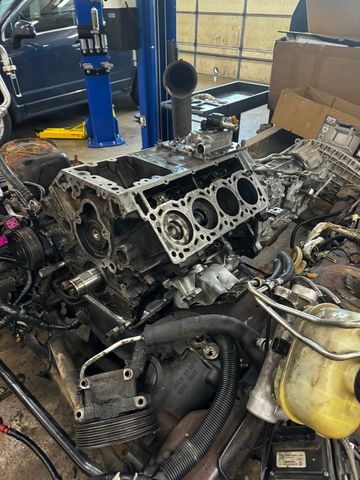 Engine block with the cylinder heads removed, still in the truck with the transmission behind it