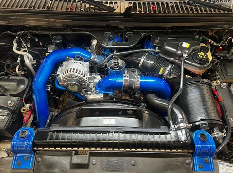 Ford truck engine bay with bright blue intercooler piping