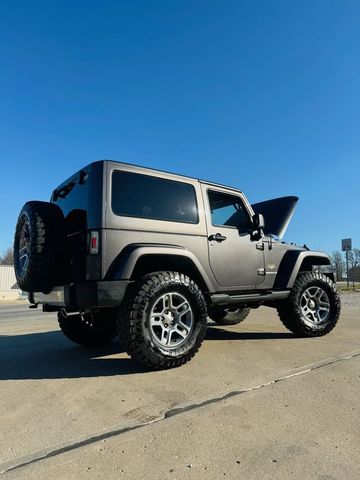 Gray Jeep Wrangler parked outside