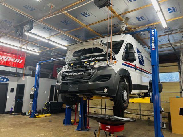 Ram ProMaster delivery van on a lift at Elite Diesel & Auto Works